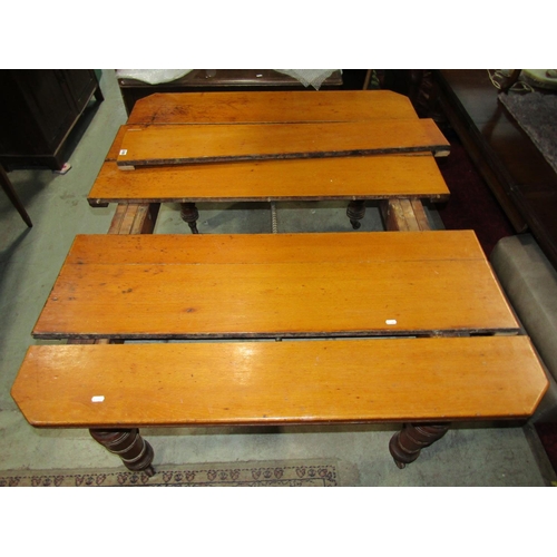 2353 - An Edwardian oak wind out extending dining table, the rectangular top with canted corners and moulde... 