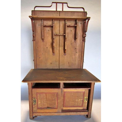 1448 - A miniature pitch pine dresser with a partially shelved upper over two sliding panelled doors, lacks... 