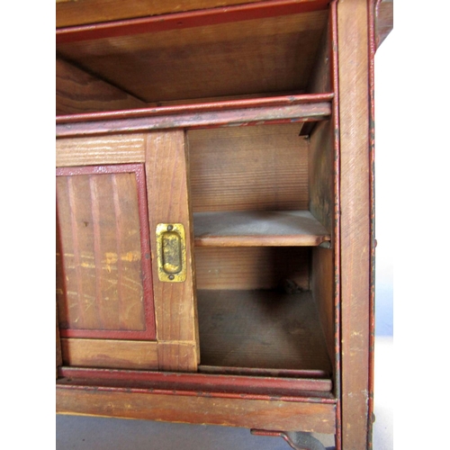 1448 - A miniature pitch pine dresser with a partially shelved upper over two sliding panelled doors, lacks... 