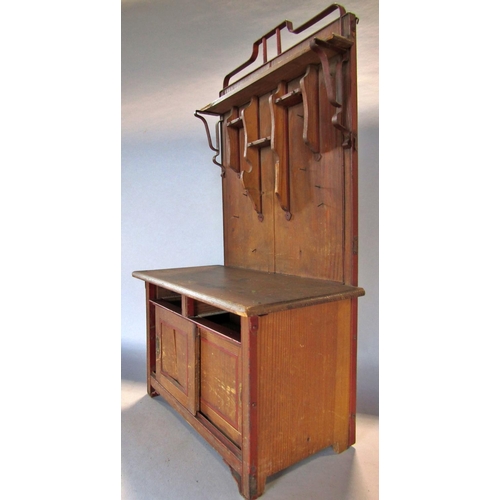 1448 - A miniature pitch pine dresser with a partially shelved upper over two sliding panelled doors, lacks... 