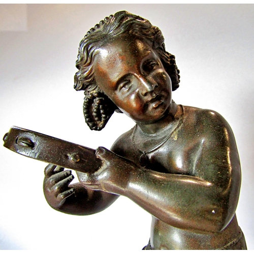 1436 - A spelter statue of a young girl doing a jig and playing a tambourine, raised on a socle base, 32cm ... 