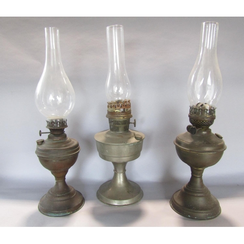 1420 - A miscellaneous collection of items including a pair worn candelabra, three brass oil lamps, a chamb... 