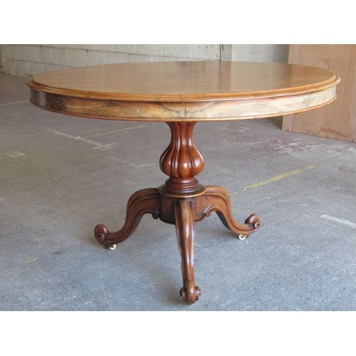 2663 - A Victorian walnut figured walnut centre table, the circular top with segmented veneers raised on ca... 