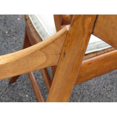 2664 - A pair of continental elbow chairs in chestnut with scrolled arms, sabre legs and rush work seats