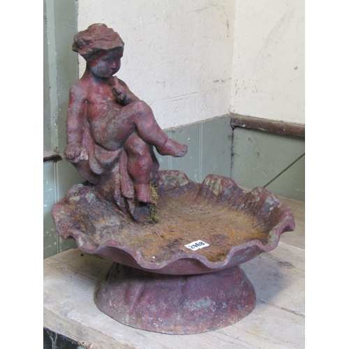 2068 - A weathered cast iron bird bath in the form of leaf, surmounted by a seated crossed legged cherub, 4... 