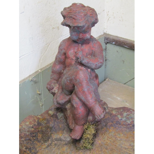 2068 - A weathered cast iron bird bath in the form of leaf, surmounted by a seated crossed legged cherub, 4... 