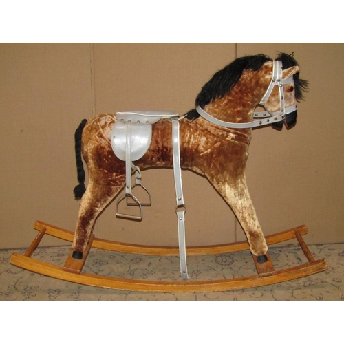 2097 - A child's toy rocking horse, complete with harness and saddle raised on a stained beechwood rocker, ... 