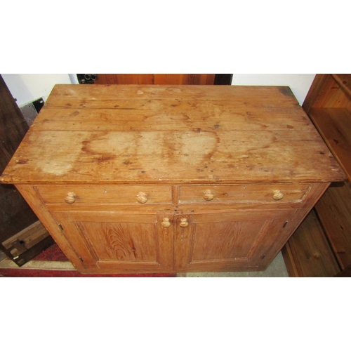 2100 - A 19th century stripped pine kitchen side cupboard enclosed by a pair of moulded panelled doors bene... 