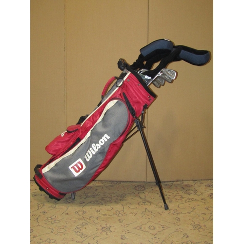 2109 - Wilson canvas golf bag containing left handed tournament, tailor made and other golf clubs