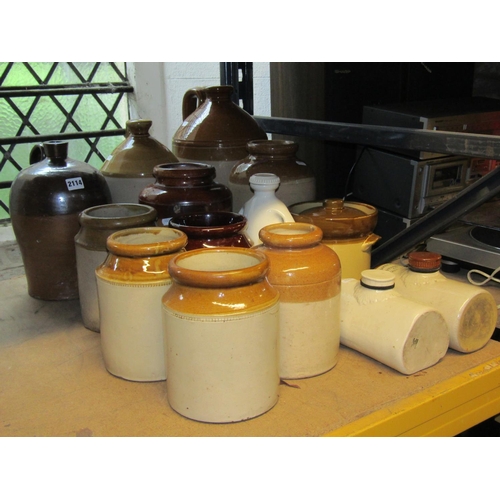 2114 - Collection of vintage glazed stoneware flagons, jars and hot water bottles of varying size and capac... 