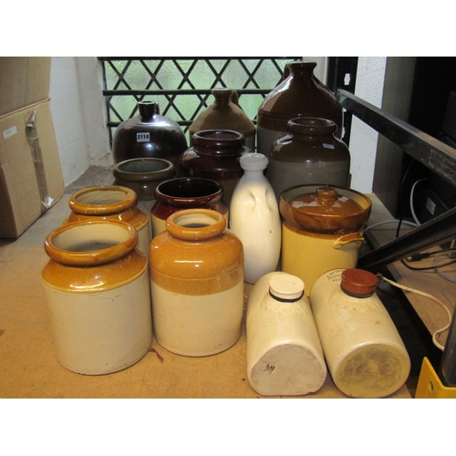 2114 - Collection of vintage glazed stoneware flagons, jars and hot water bottles of varying size and capac... 