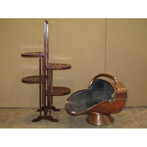 2236 - 19th century copper helmet shaped coal scuttle, together with an Edwardian mahogany folding cake sta... 