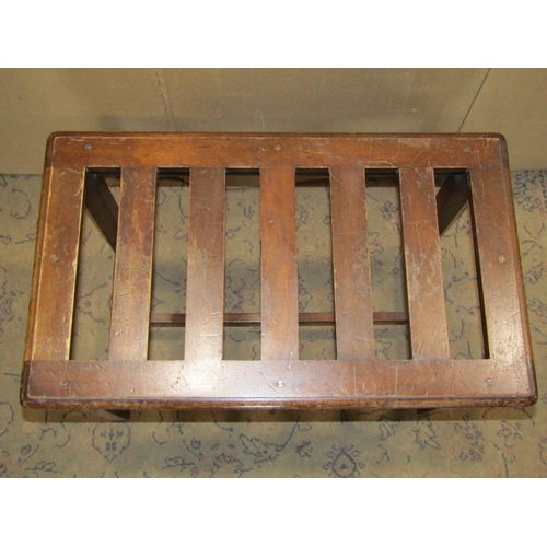 2257 - An Edwardian walnut luggage stand of rectangular form with open slatted top, raised on square cut an... 