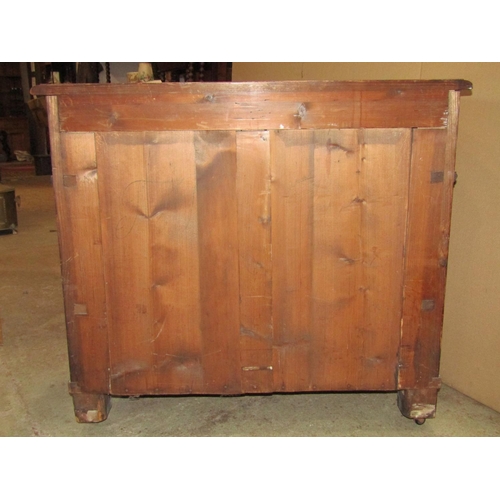 2270 - 19th century walnut veneered commode of three long drawers, flanked by mock columns set on turned bu... 