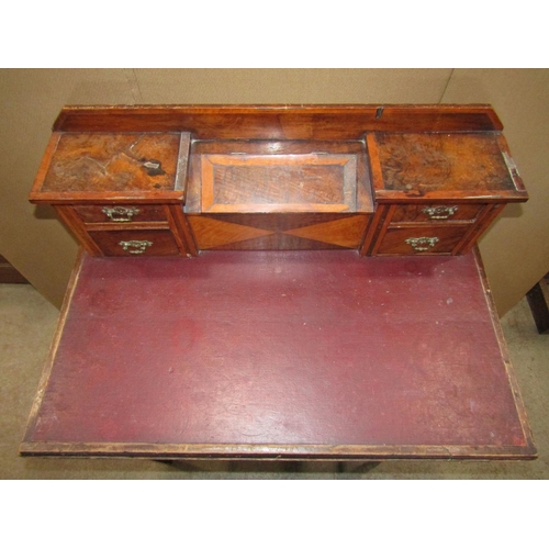 2278 - A walnut and satinwood veneered writing table, the recess raised back incorporating four small drawe... 