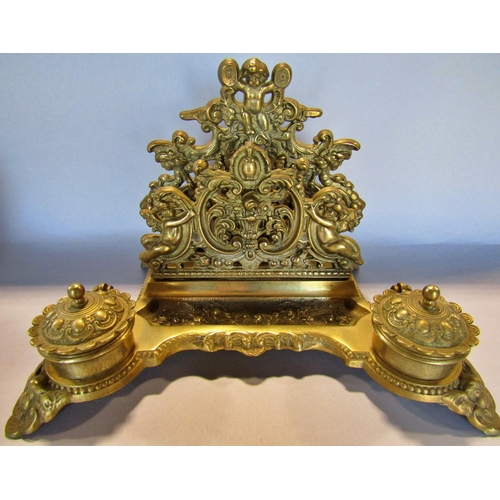 1456 - An impressive brass Empire ink well with mask and floral detail to the square swept base, together w... 