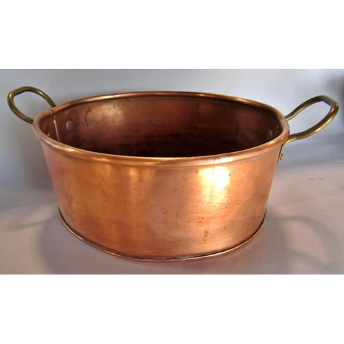 1465 - A 19th century copper flat bottomed pan with brass handles, 40cm diam, a smaller oval copper pan, a ... 