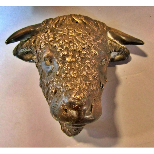 1476 - A brass figure of a badger, a brass bull’s head and a carved wood head of a falcon. 3