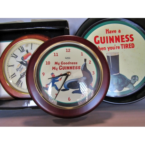 1478 - Guinness Memorabilia, two wall clocks and a pair of tin drinks trays.