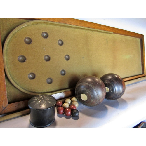 1480 - A vintage table top bagatelle board a selection of nine different coloured balls, one cue, together ... 