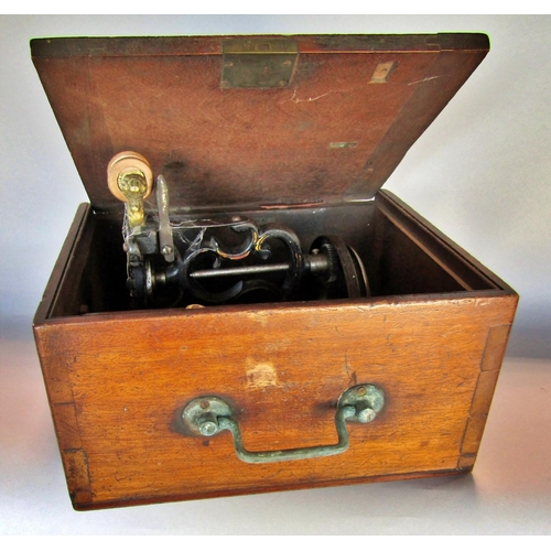 1505 - A small un-marked sewing machine housed in a mahogany carry case.