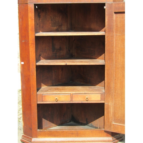 2391 - A Georgian oak hanging corner cupboard enclosed by a rectangular moulded and crossbanded rectangular... 