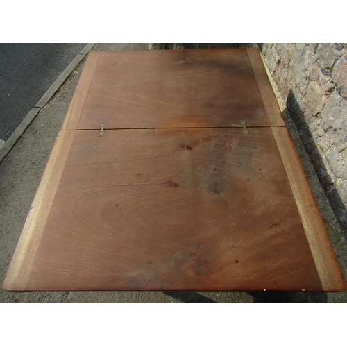 2398 - A Victorian mahogany rectangular fold over top table raised on turned supports with brass caps and c... 