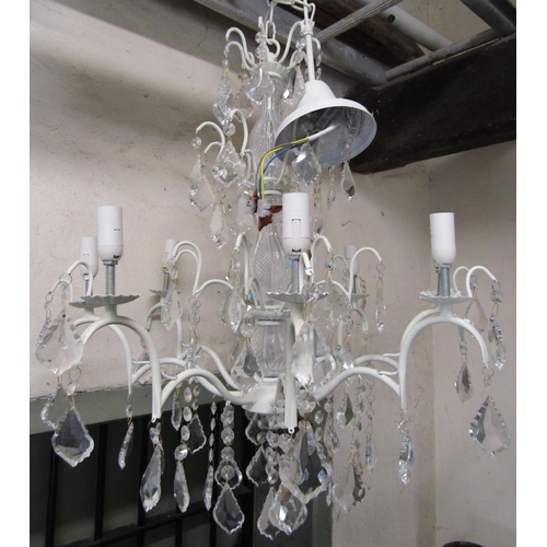 2400 - A contemporary eight branch cream painted light metal chandelier with moulded glass stem and faceted... 