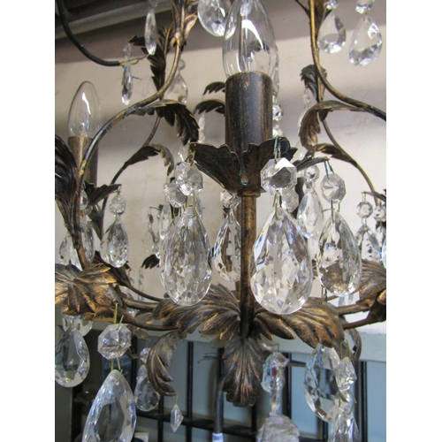 2403 - A contemporary light metal chandelier with five candle bulb fittings scrolling leaf detail, faceted ... 