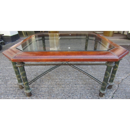 2414 - A good quality centre table, raised on eight brass supports united by an X shaped stretcher, the top... 