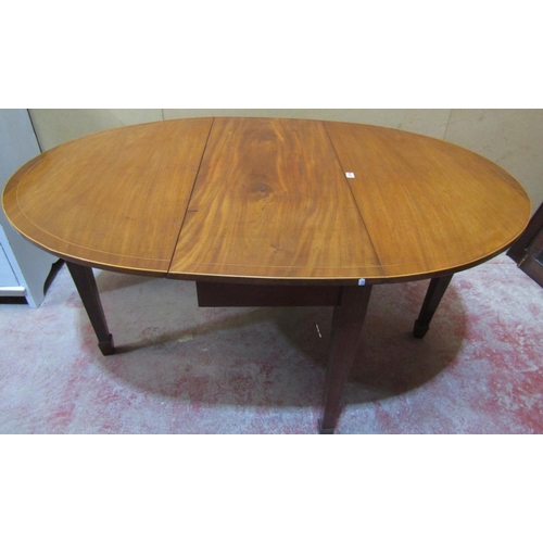 2449 - A mahogany drop leaf dining table raised on square tapered legs with spade feet, with simple string ... 