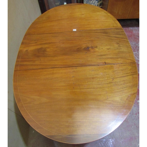 2449 - A mahogany drop leaf dining table raised on square tapered legs with spade feet, with simple string ... 