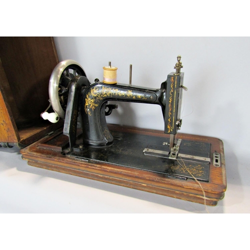 1539 - A vintage table top sewing machine, make unknown, with a walnut and mahogany inlaid case.