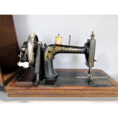 1539 - A vintage table top sewing machine, make unknown, with a walnut and mahogany inlaid case.