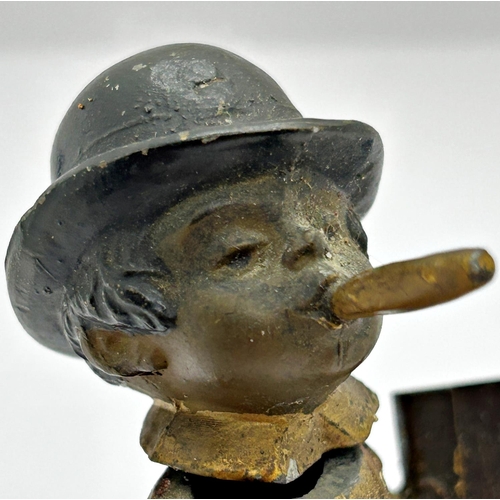 1404 - Vintage spelter advertising figure in the form of a young boy in dungarees smoking a large cigar and... 