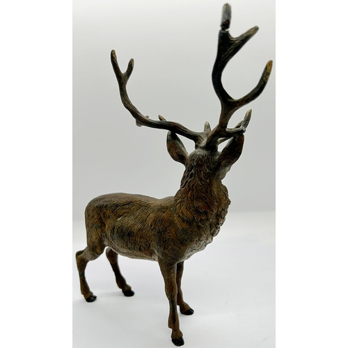 1405 - A spelter figure of a stag with antlers, naturalistically painted together with a small cold cast br... 