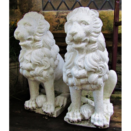 2008 - A pair of painted cast composition stone garden terrace or pier ornaments in the form of seated lion... 