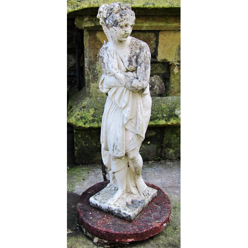 2014 - A weathered cast composition stone garden ornament in the form of a standing classical female, proba... 