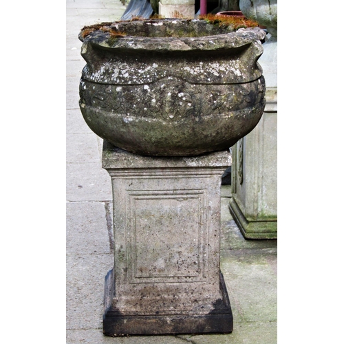 2027 - A weathered cast composition stone cauldron shaped garden urn with flared rim and repeating foliate ... 