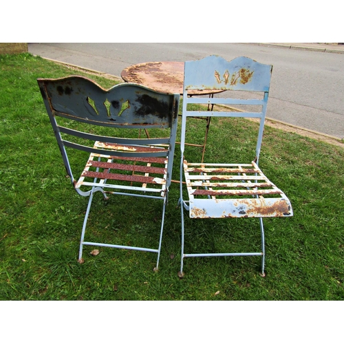 2032 - A painted steel three piece garden terrace or bistro set, with pierced and applied floral detail, (a... 