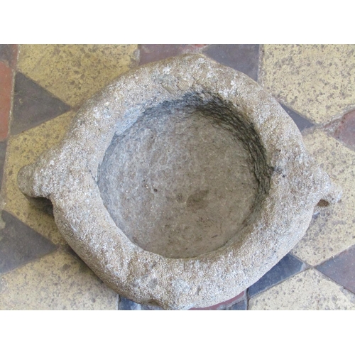 2056 - A small early carved granite mortar with pronounced lugs, approx 30cm diameter  x 20cm high