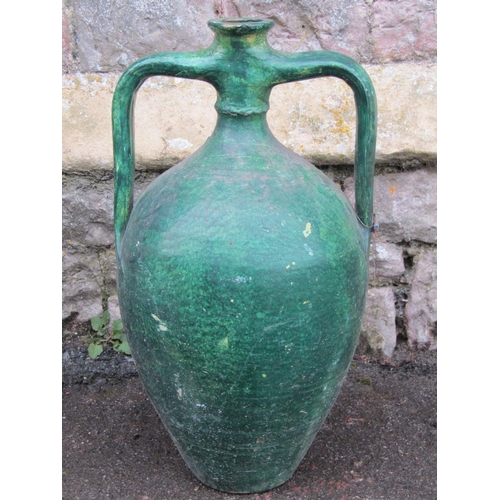 2071 - A vintage green painted bottle jar with moulded loop handles and simple incised banded detail, 55cm ... 