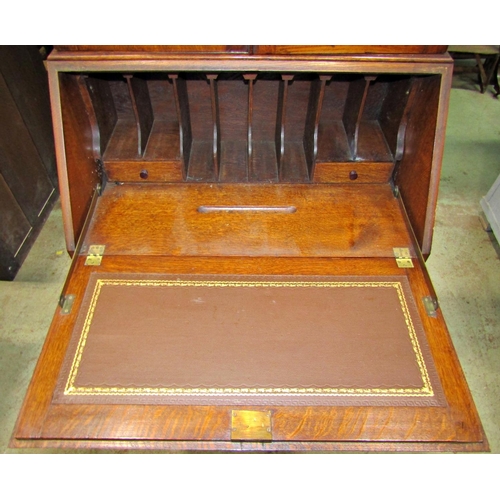 2195 - 1920s Jacobean revival oak bureau bookcase with blind fretwork and split moulded detail, raised on s... 