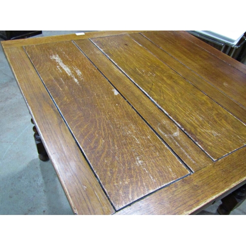 2234 - A 1920s oak drawleaf dining table raised on barley twist supports united by a moulded X framed stret... 