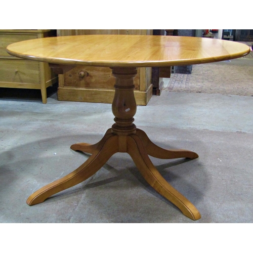 2237 - A contemporary cherry wood breakfast table with circular top raised on a turned vase shaped pillar a... 