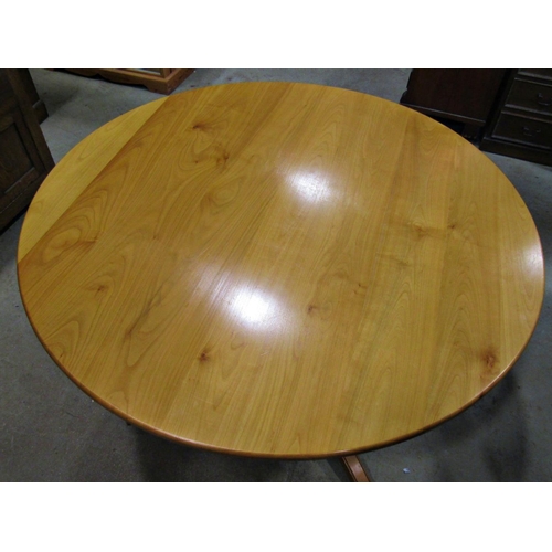 2237 - A contemporary cherry wood breakfast table with circular top raised on a turned vase shaped pillar a... 