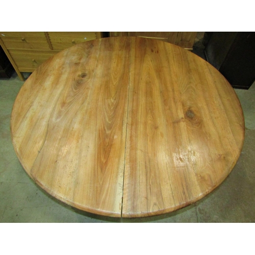 2239 - A circular bleached hardwood dining table, raised on four turned tapered  supports, 130cm diameter x... 