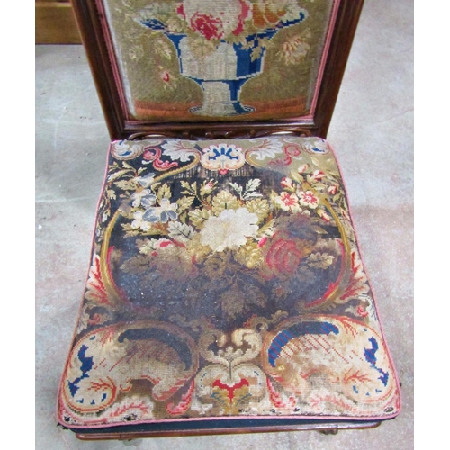 2240 - A Victorian rose wood predu, with floral tapestry upholstered seat and T shaped back within a show w... 