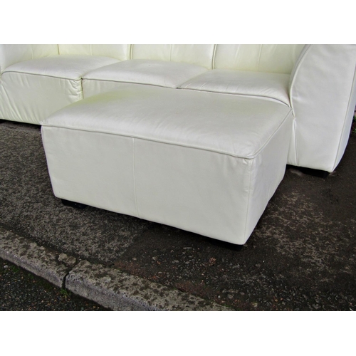 2312 - A contemporary stitched cream leather upholstered three sectional sofa and matching rectangular stoo... 