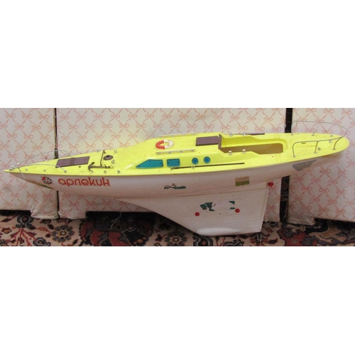 369 - Fibre glass motorised pond yacht on stand with orange hull, length 92cm together with a smaller moto... 